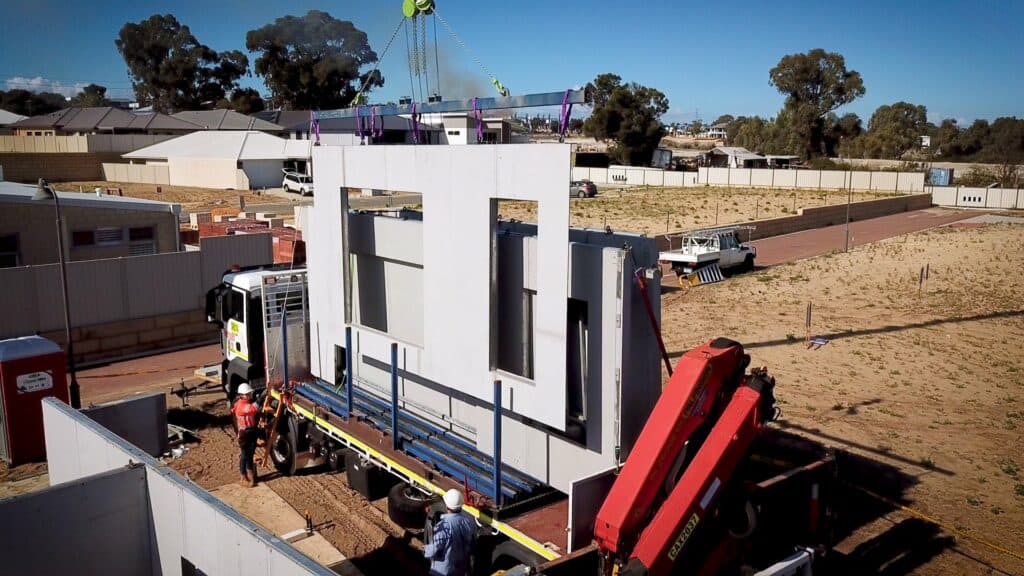 Rock Max pre-built panels being unloaded off of a trailer before installation.