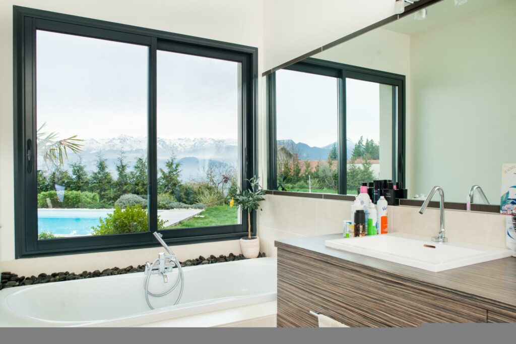 Sliding windows in a bathroom above the tub